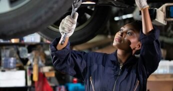 Where should you get your car serviced - at an auto shop or a dealership? 